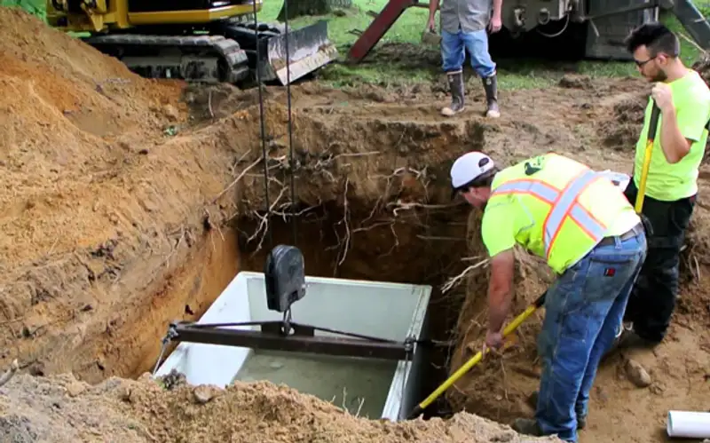 Heavy excavator preparing a residential site for foundation protection and drainage system installation in El Paso, TX