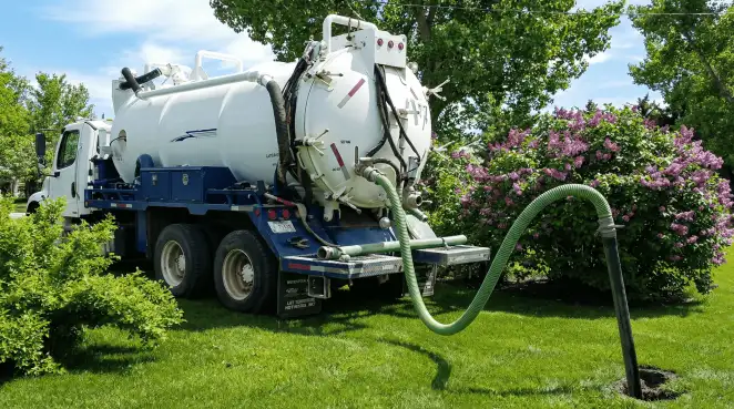 Professional vacuum truck performing residential drainage and septic maintenance in El Paso, TX