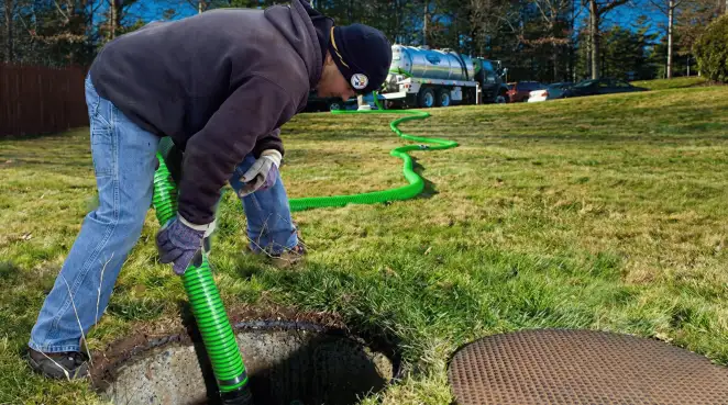 Service technician performing residential septic pumping and drainage maintenance in El Paso, TX